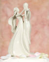 stylized white porcelain dancing bride and groom wedding cake topper