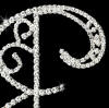 close-up view of crystal monogram roman font wedding cake topper