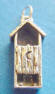 sterling silver outhouse charm - you can see legs and a head behind the door