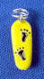 yellow enamel 3-d sterling silver skateboard charm with black enamel footprints design