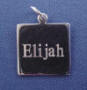 close-up of engraving on charm front the name Elijah