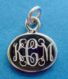 A sterling silver monogramed oval charm