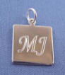sterling silver square charm with letters m and j engraved in lucidia font