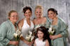 The bride is wearing our mother of pearl lariat-style calla lily jewelry set, her bridesmaids are wearing single drop mother of pearl calla lily necklaces, the bride's daughter is wearing a single drop calla lily necklace, too.