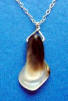 you can see the black, golden and white colors in the back of this calla lily pendant