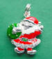 sterling silver santa charm wearing a red enamel suit accents with rhinestones and holding a green enamel wreath