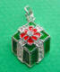 sterling silver green enamel gift with red enamel flower on top and clear cubic zirconia stones as ribbon