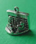 sterling silver 3-d charm of two children opening gifts in front of a fireplace