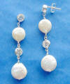 This pair of handcrafted sterling silver earrings features 9mm and 11mm coin pearls and cubic zirconia stones.