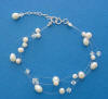 This bride's bracelet is a triple-strand pearl and crystal illusion bracelet with a sterling silver clasp and extender.