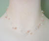 Double-strand illusion necklace with clear and peach Swarovski crystals