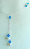This bridesmaid's necklace has the double lariat design with freshwater pearls and blue crystals