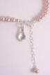 sterling silver family heirloom christening charm on back of this pearl necklace