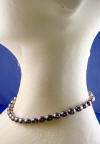 side view of peacock pearl necklace