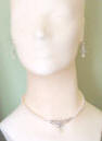 freshwater pearl necklace with sterling silver festoon drop in front that is a calla lily