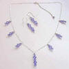 sterling silver station necklace and earrings shown with larger focal center point