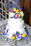 wedding reception charm cake - notice the charms are on purple ribbons around the bottom cake tier.