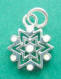 sterling silver snowflake charm with white enamel accents