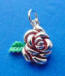 sterling silver rose charm with red enamel accents and green enamel leaf