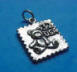 sterling silver postage stamp with a teddy bear charm