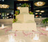 wedding cake with orchids and wedding cake charms on satin ribbons for the wedding cake pull