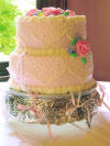 bridesmaid's charm cake with ribbons under the cake