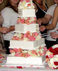 pulling charms from square layer wedding cake