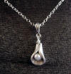 this petite calla lily pendant is hill tribe silver with freshwater pearl center