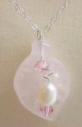 This rose quartz calla lily pendant is accented with a freshwater pearl and Swarovski light rose crystals