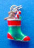 sterling silver green and red enamel christmas stocking stuffed with a brown bear, red candy cane and green gift box