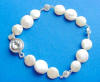 This handcrafted coin pearl bracelet has 9mm and 11mm coin pearls, 5mm cz spacer links and cz clasp.