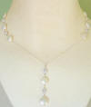This coin pearl necklace has 2 coin pearl and cz stations on the sides and a dangle coin pearl cz drop.