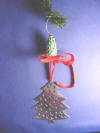 christmas tree ornament hanger on a christmas tree branch with a sterling silver christmas tree ornament