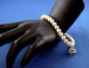 bridal pearl bracelet with round pearls and wedding cake charm