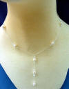 This sterling silver bridal necklace features freshwater pearls, sterling silver beacaps, and Swarovski crystals