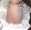 christening bracelet with croos charm and family heirloom charm