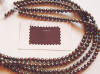 The bridesmaid's gowns are a rich chocolate brown - we found dyed pearls to match the gown colors.