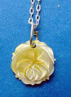 notice the multi-color hues in this golden mother of pearl rose pendant