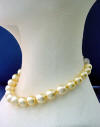 This golden shell pearl necklace has shell pearls from 12mm to 16mm with a sterling silver rhinestone clasp.