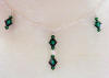 the center of this necklace has Swarovski emerald green and crystal champagne crystals