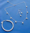3-piece pearl jewelry set - station necklace with round pearls dangling from the chain, line pearl bracelet, and pearl drop earrings